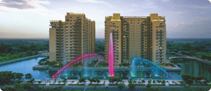 Two residential towers behind a lit fountain
