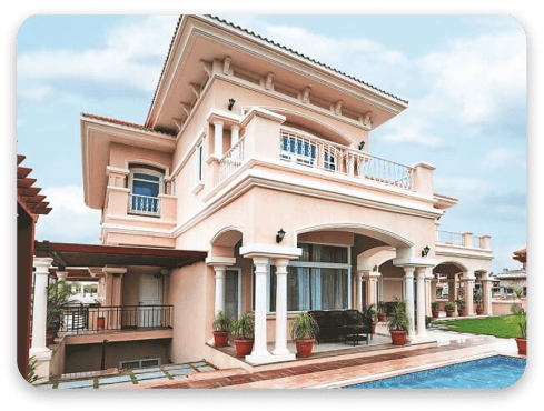 A two-storey villa with arched verandas beside a pool